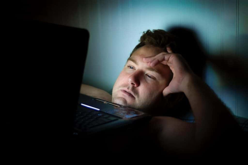 Man on Computer | Activating night shift mode actually leads to better sleep