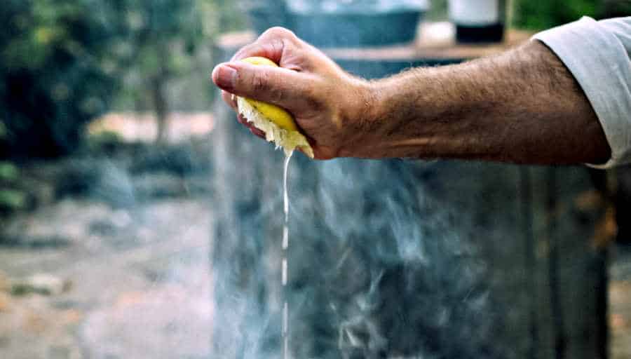 Lemon Water Can Change Your Life As A Shift Worker - Man squeezing lemon over smoke - The Other Shift 