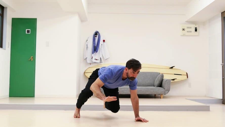 15 Key Reasons for Shift Workers to Ditch the Gym and Start Exercising at Home - Man stretching on the floor wearing blue shirt - The Other Shift
