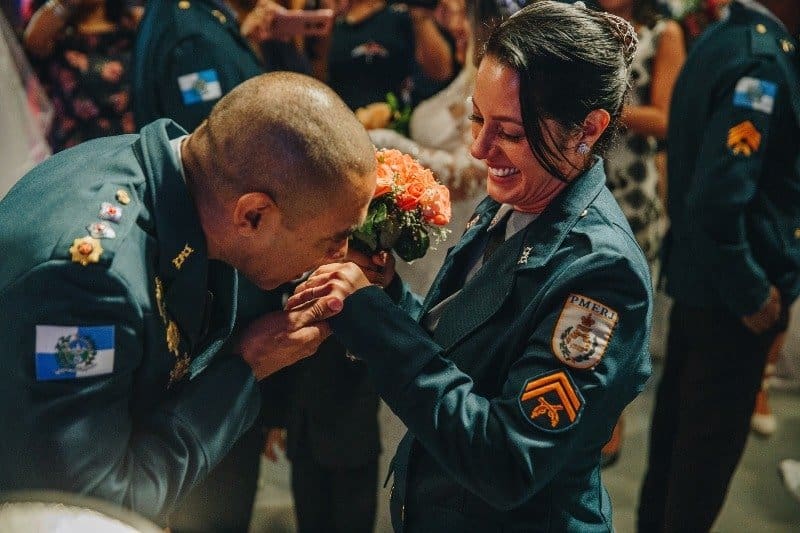 Army man kissing hand of army women