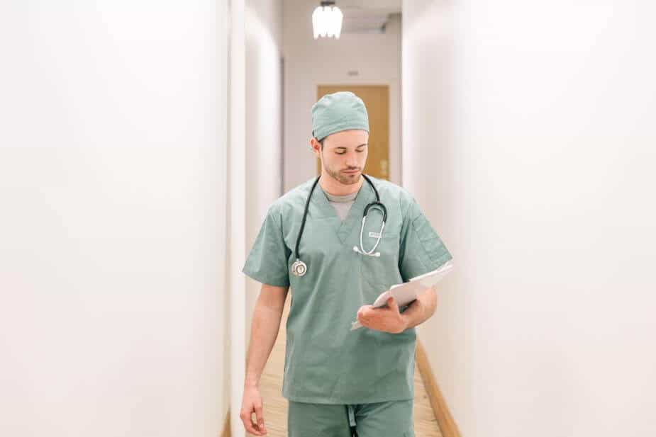 doctor walking down hallway with clipboard working rotating shifts